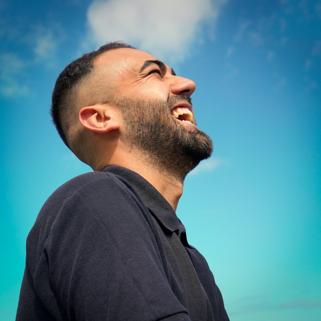 Studio portrait of a Brazilian man with a short beard smiling