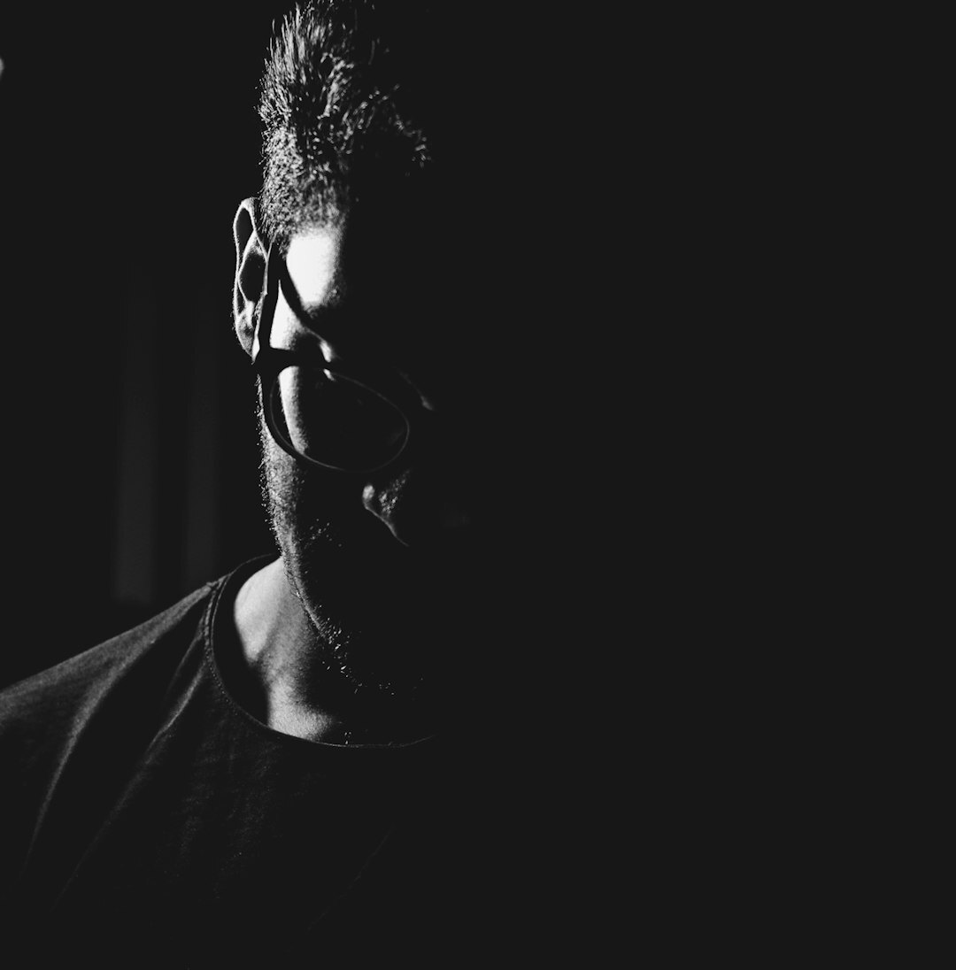 Studio portrait of a middle aged Brazilian man wearing glasses